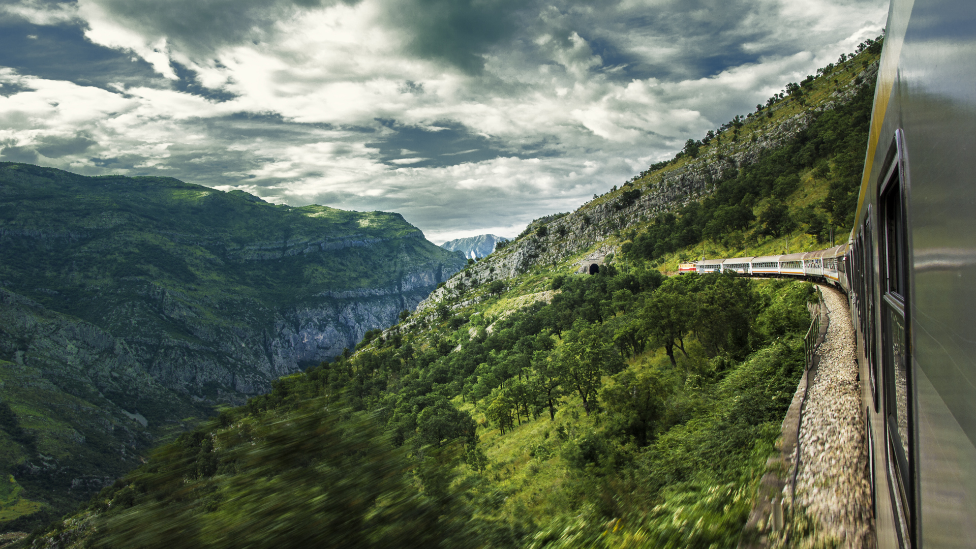 View from a moving train entering the Moraca canyon on a cloudy day, Montenegro