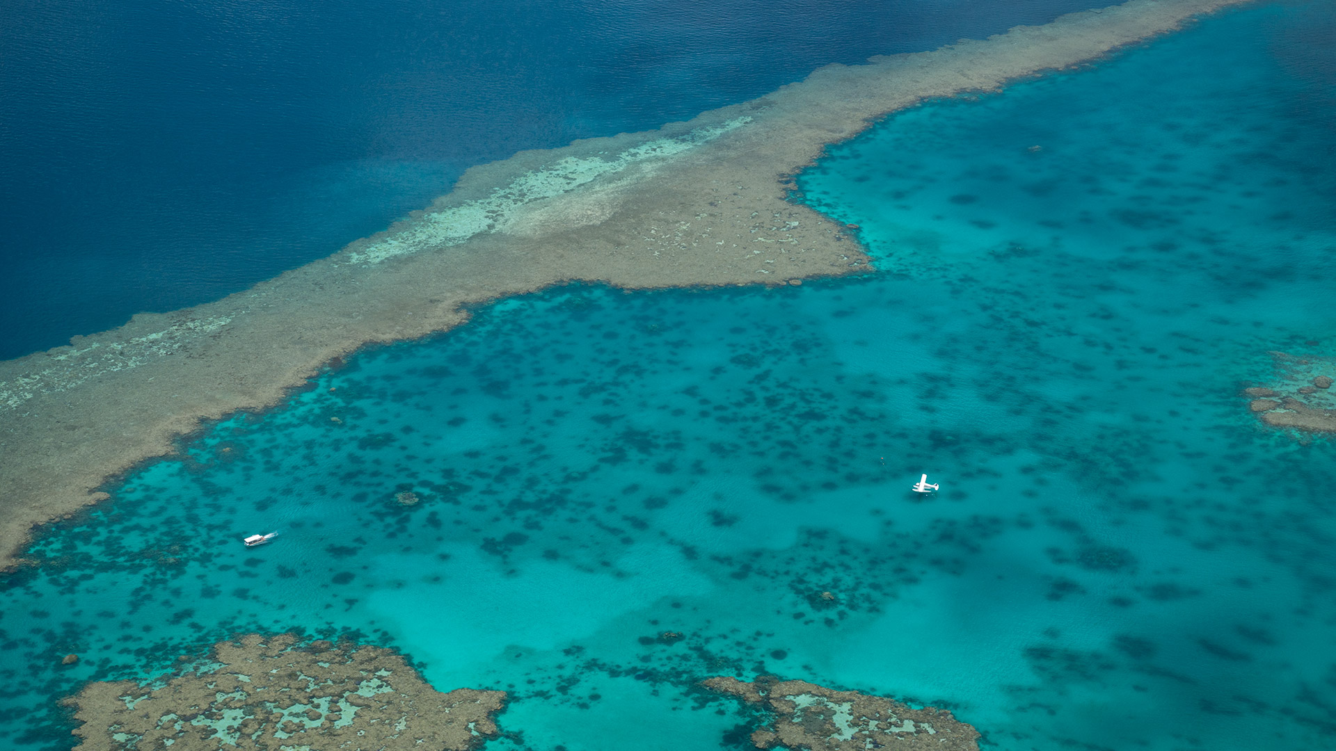 Floatplane on surface of waters of Great Barrier Reef, Airlie Beach, Queensland, Australia