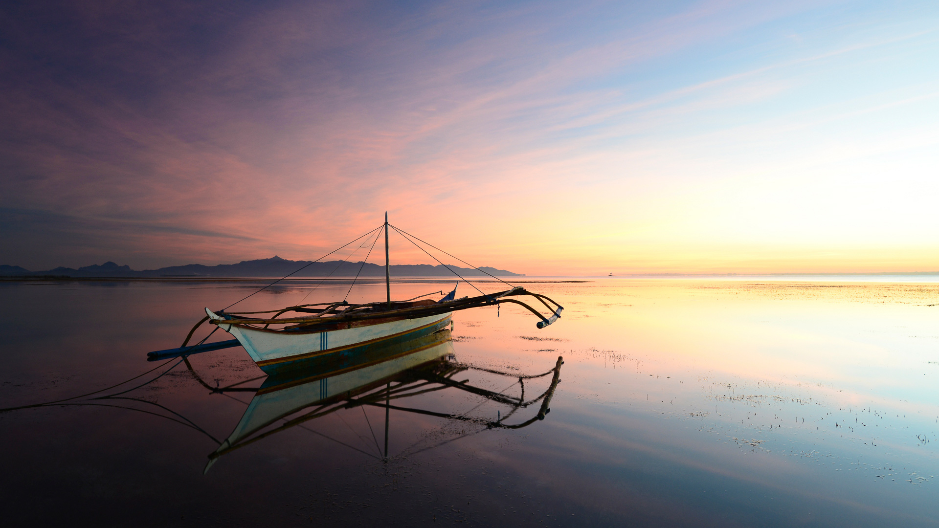 The quiet fire, boat on water at sunset, Puerto Princesa, Philippines