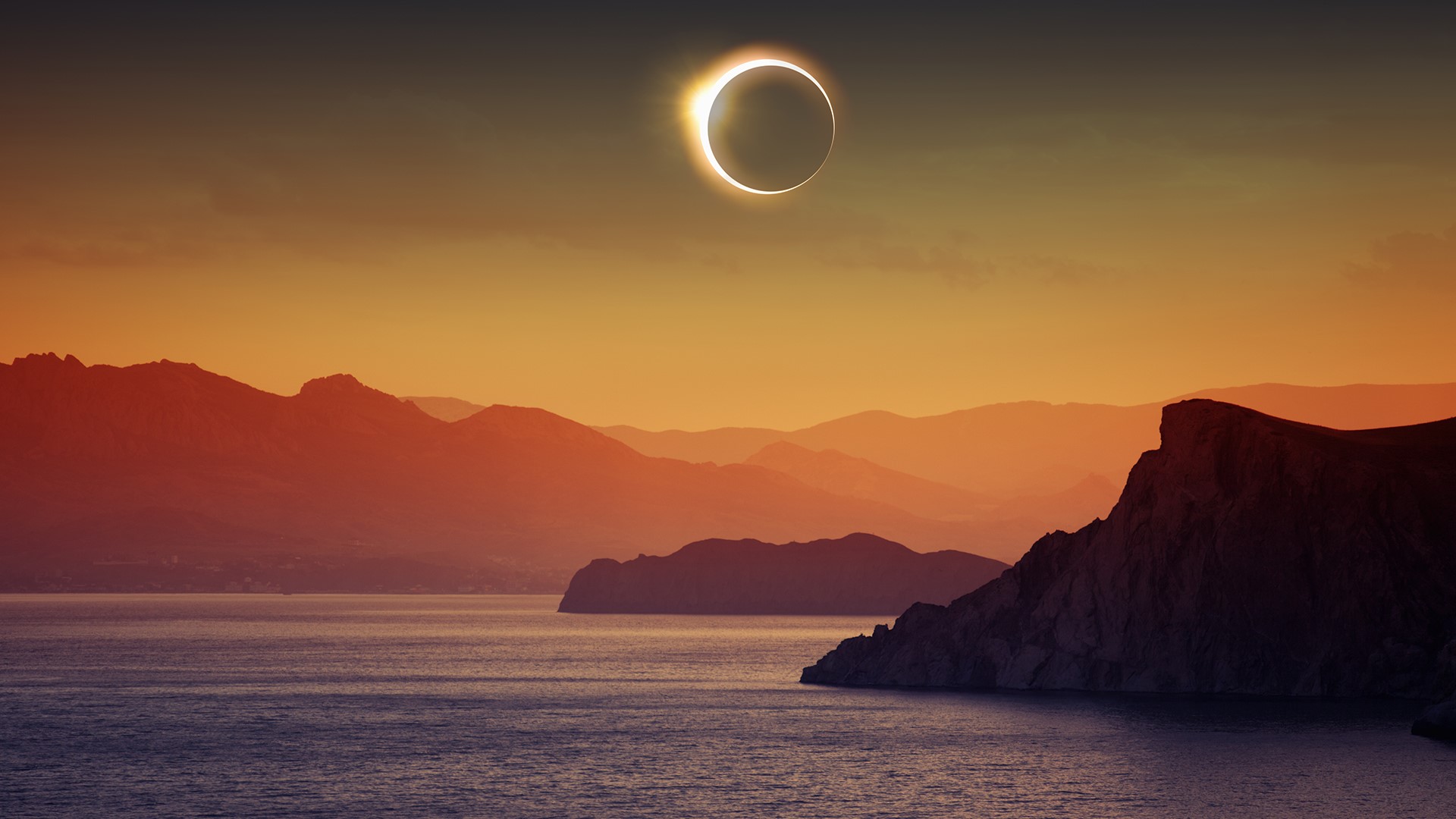 Total solar eclipse, mountains and sea