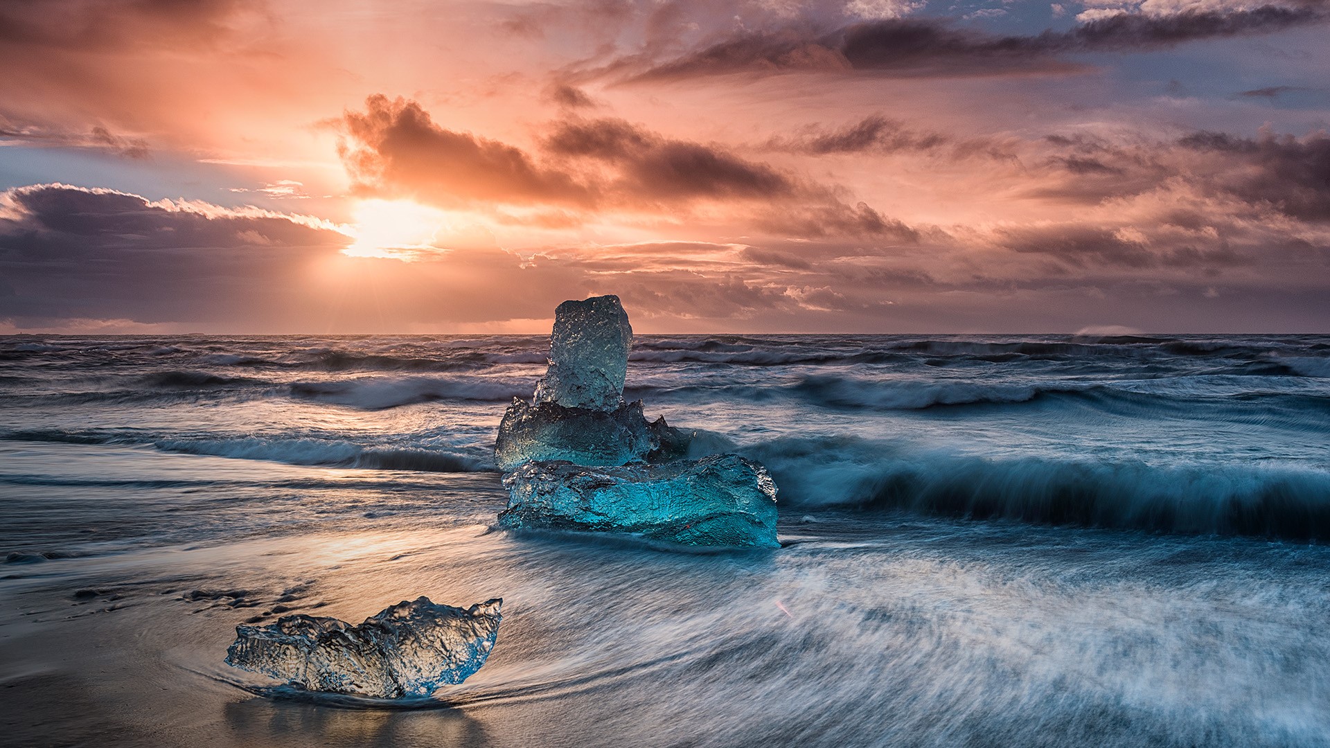 Icebergs floating on icy beach at sunrise, Jökulsárlón Lagoon, south Iceland