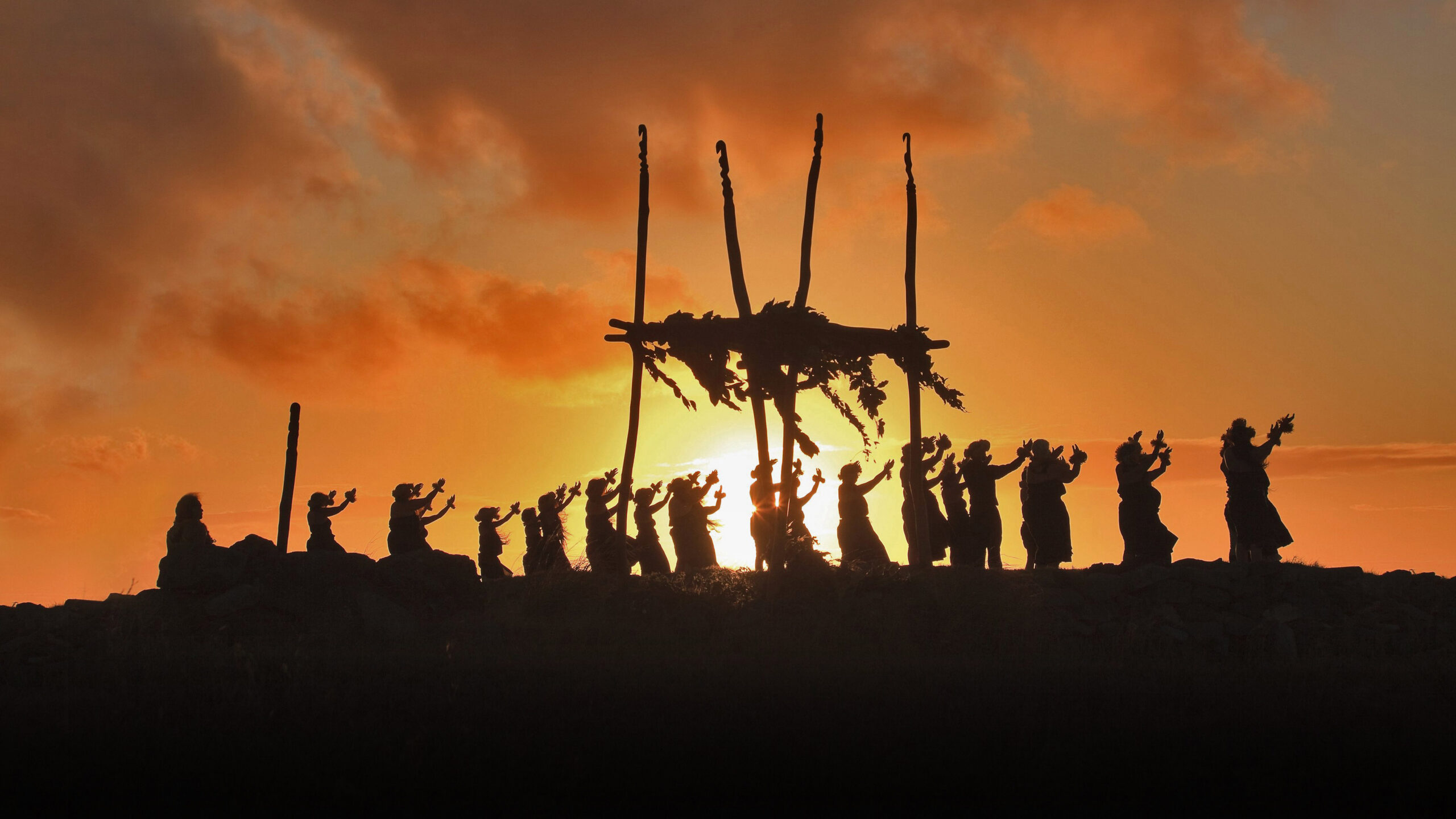 Dancers on a hula pa'a on the site of a lele (altar) on the island of Molokai, Hawaii
