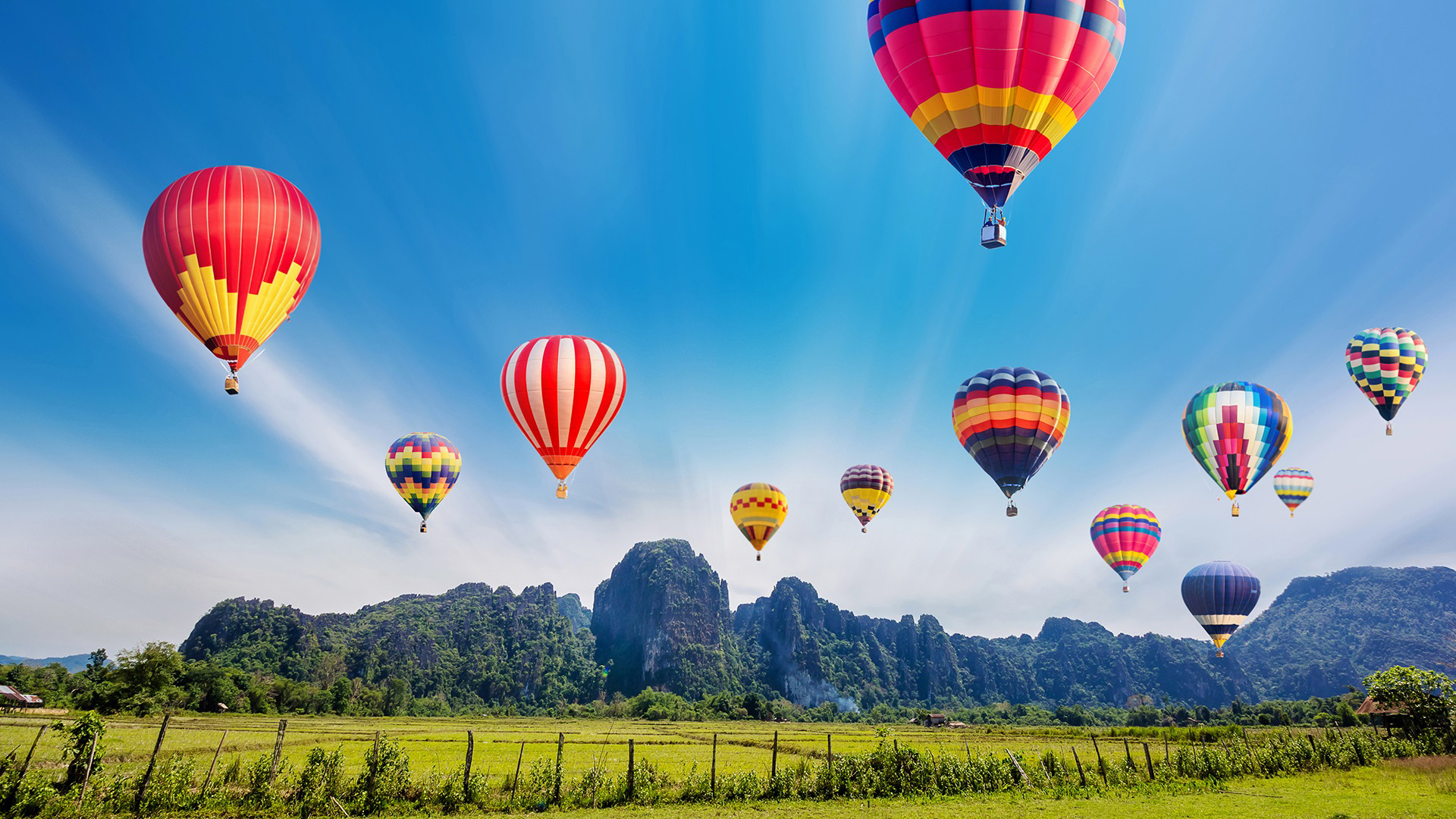 Colourful hot-air balloons flying over the mountain