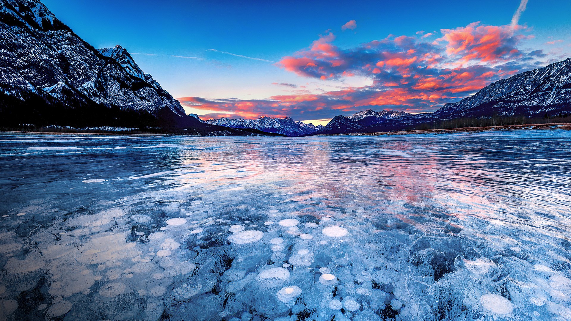 Stacks of methane bubbles under ice in Abraham Lake at sunset, Alberta, Canada