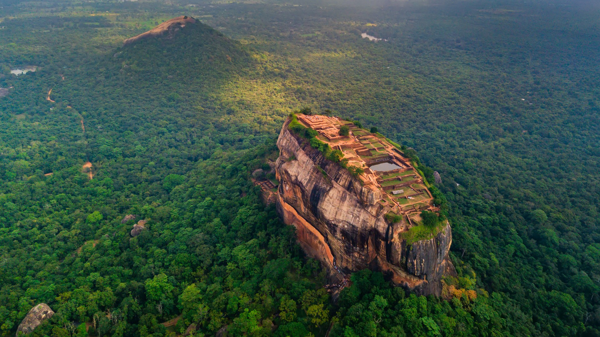 Aerial view of Sigiriya rock fortress at misty morning, Matale District, Sri Lanka