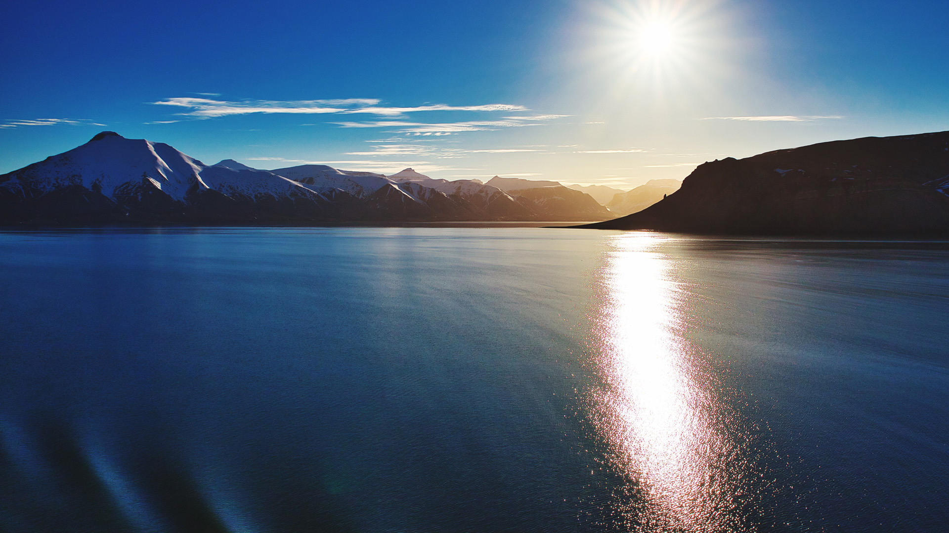 Scenic view of lake against blue sky, Spitsbergen, Norway