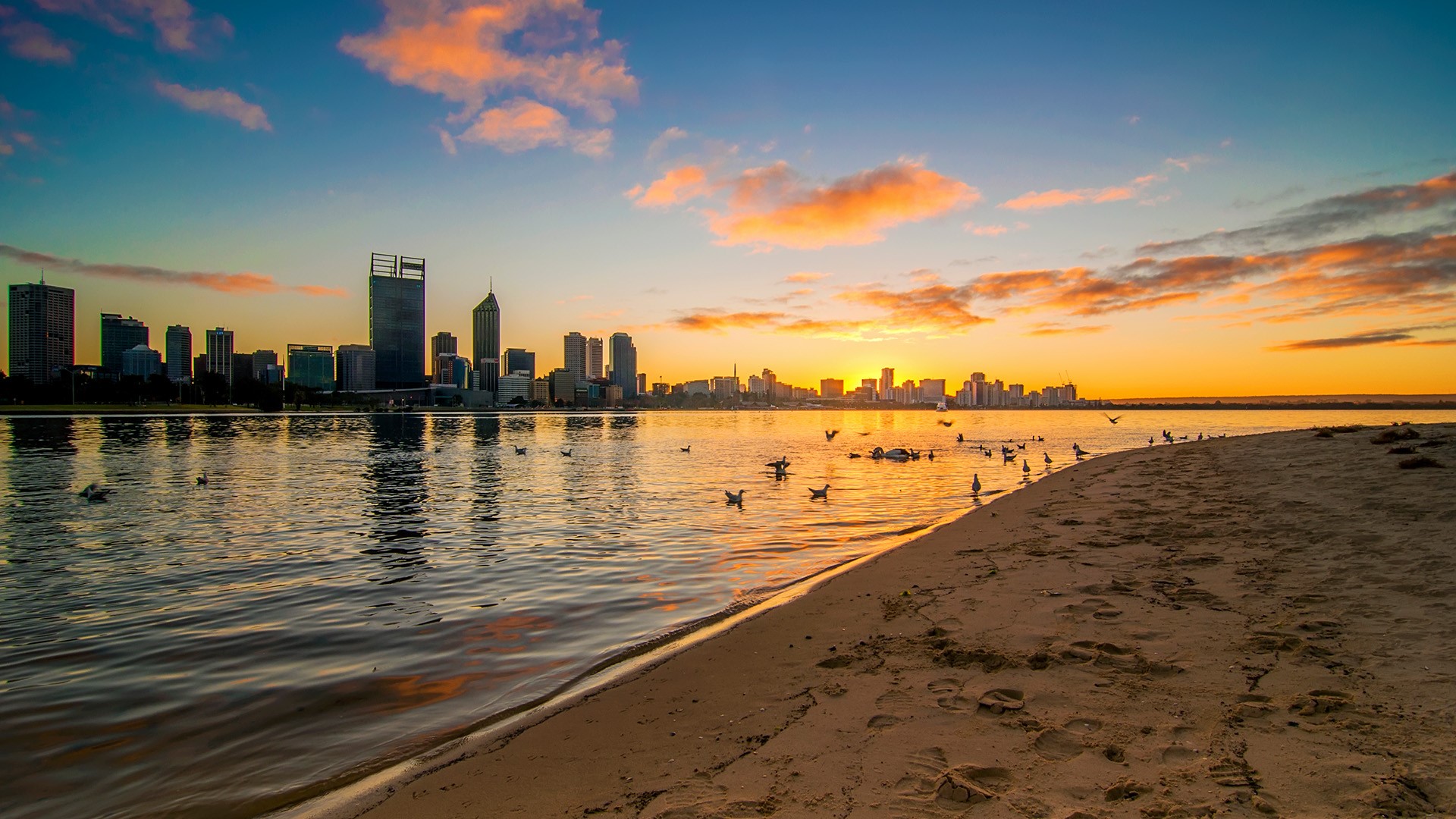 Golden sunrise view of Perth skyline from Swan River, Australia