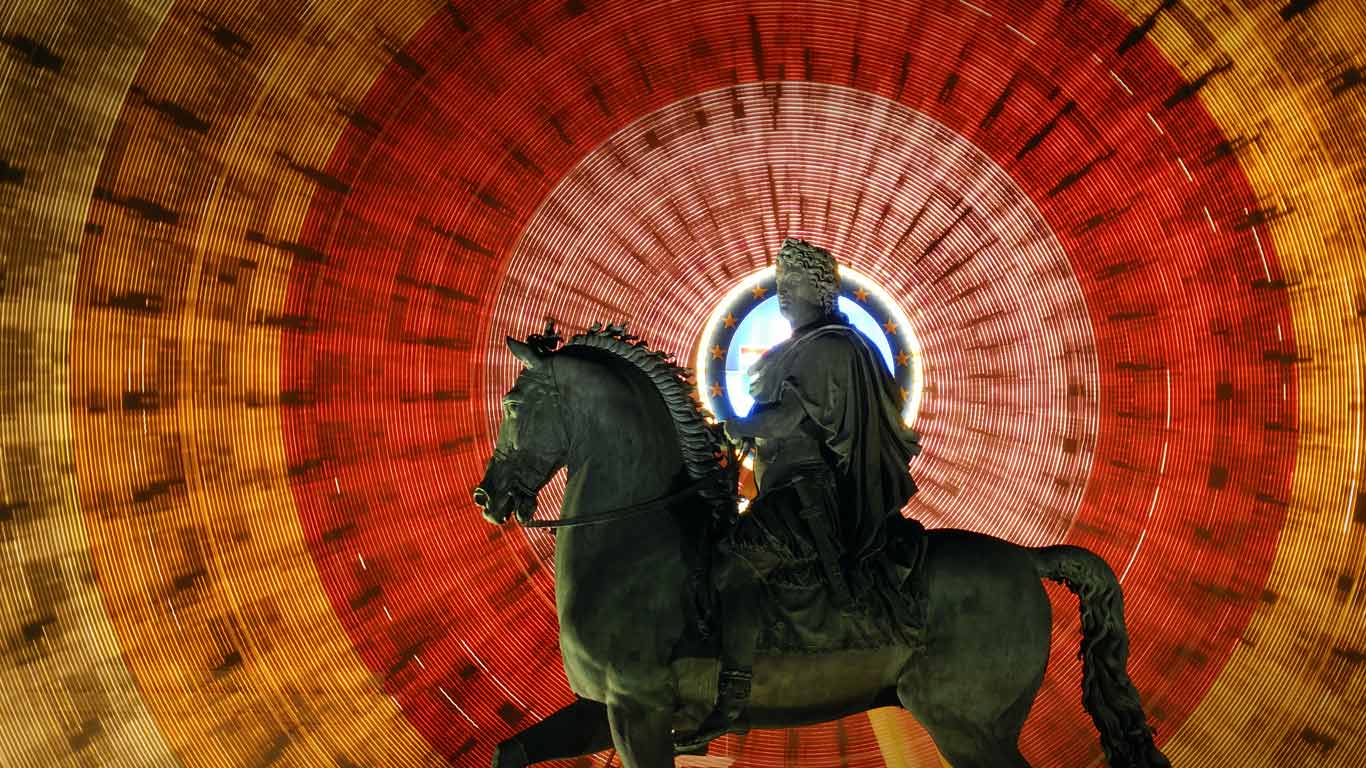 Louis XIV statue and spinning Ferris wheel at Place Bellecour in Lyon, France