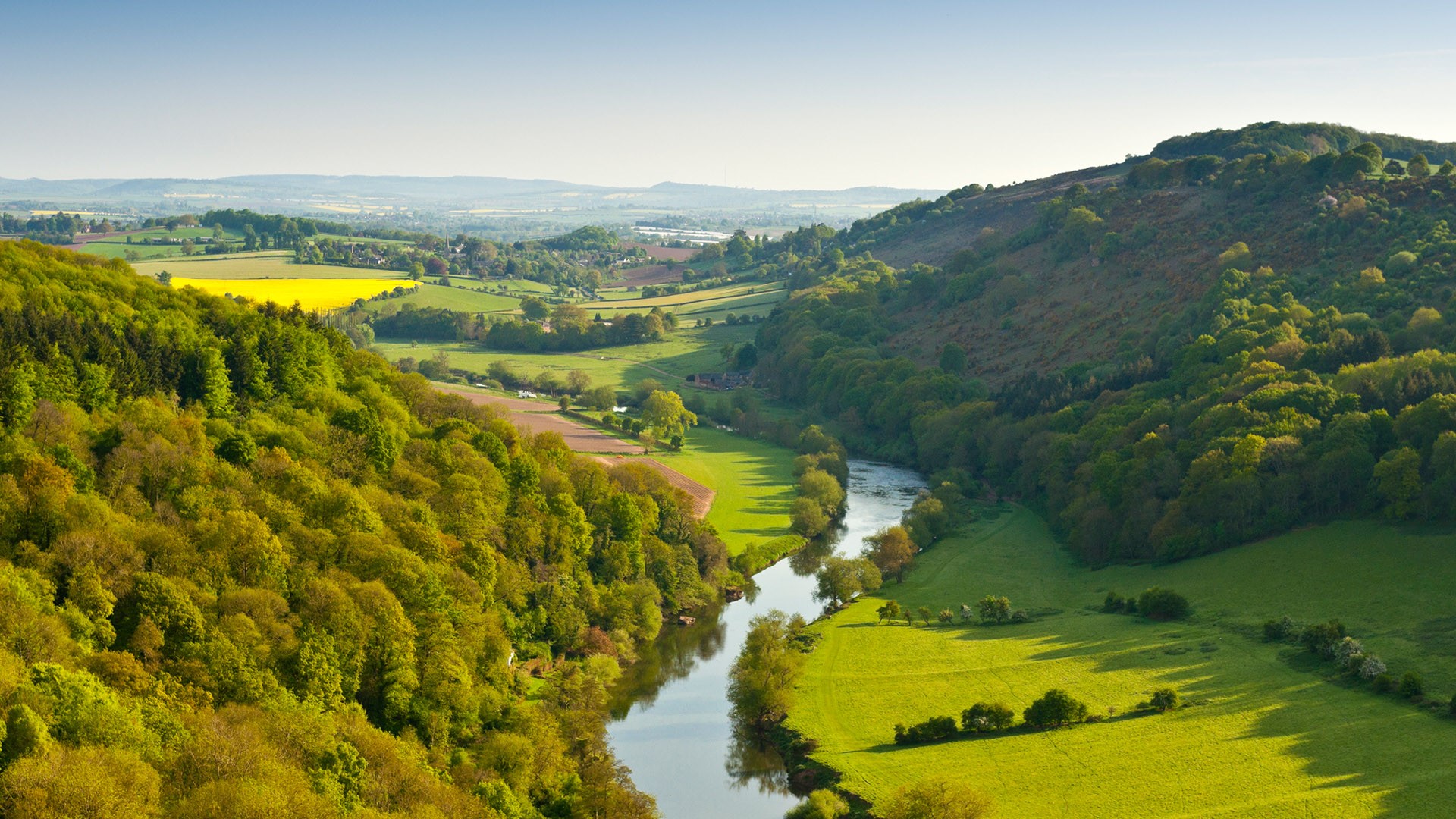 River Wye making its way through lush green rural farmland, Cotswolds, UK